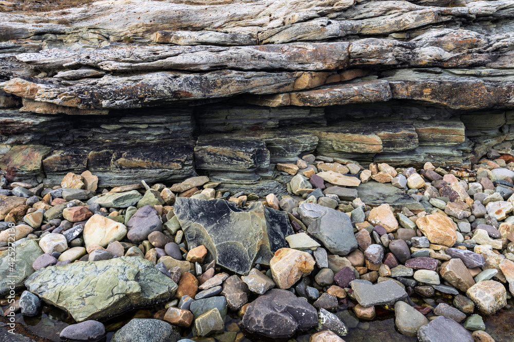 Natural seashore stones and slate rock, Arctic Ocean coastline in Varanger peninsula, Finnmark, Norway Natural seashore stones and slate rock, Arctic Ocean coastline in Varanger peninsula, Finnmark, Norway