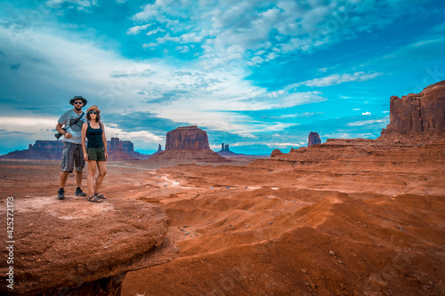 A young couple of Europeans at John Ford's Point in Monument Valley. Utah.