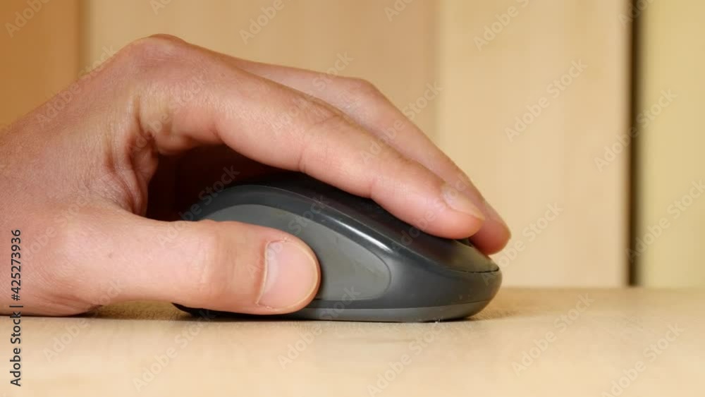 A Man use Computer Mouse clicking working on a Table - close-up A Man use Computer Mouse clicking working on a Table - close-up