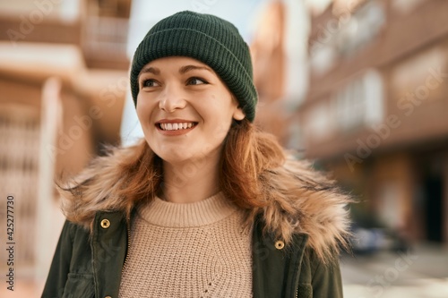 Young caucasian girl smiling happy standing at the city.