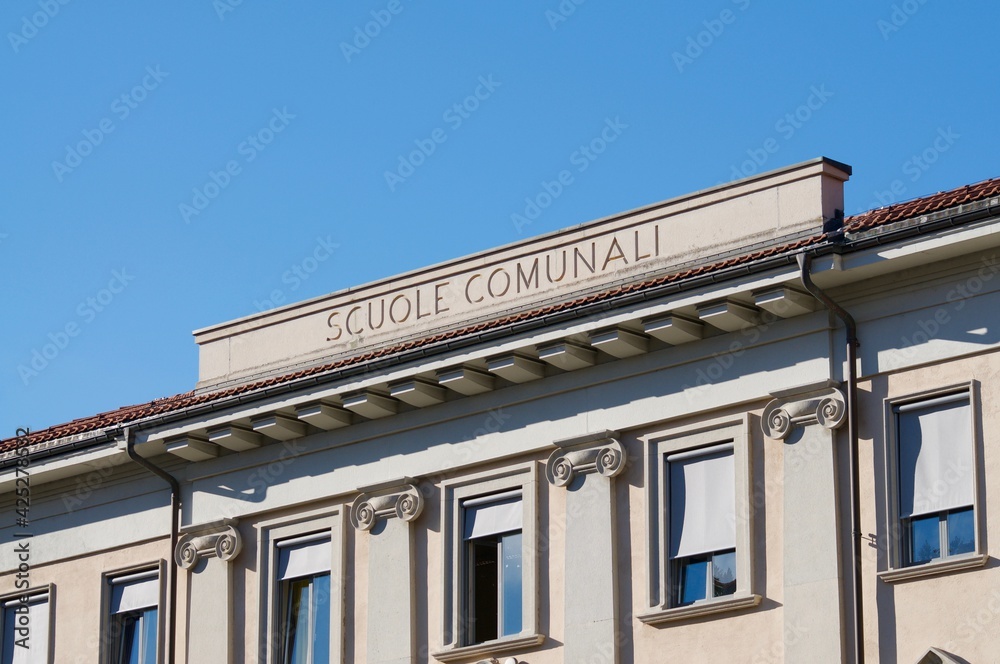 School building facade with scuole comunali inscription in Lugano, Switzerland
