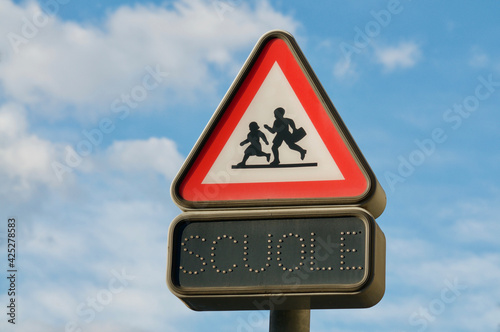 Swiss italian school warning sign against blue sky photo
