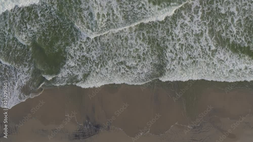Aerial of frothy waves reaching beach Aerial of frothy waves reaching beach