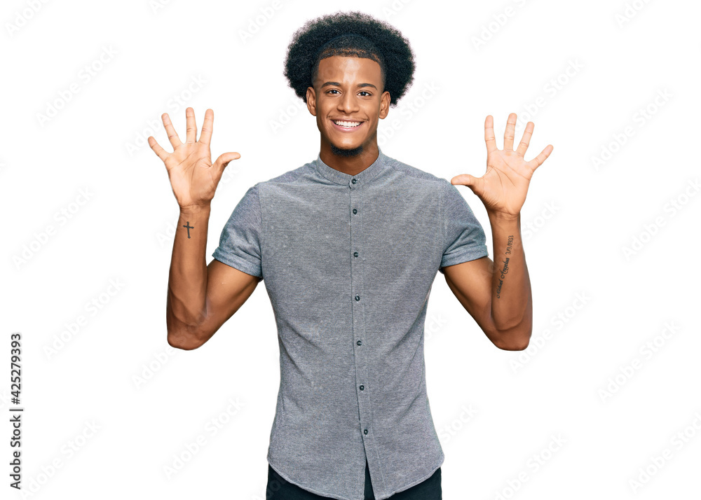 African american man with afro hair wearing casual clothes showing and pointing up with fingers number ten while smiling confident and happy. African american man with afro hair wearing casual clothes showing and pointing up with fingers number ten while smiling confident and happy.