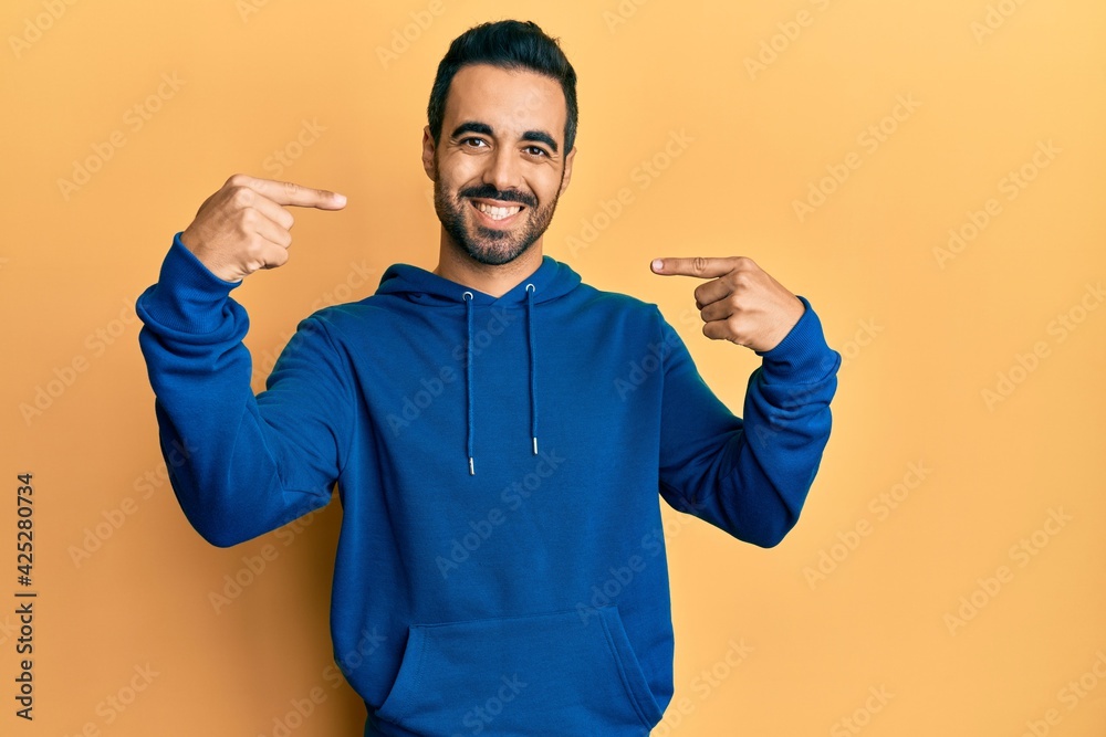 Young hispanic man wearing casual clothes smiling cheerful showing and pointing with fingers teeth and mouth. dental health concept. Young hispanic man wearing casual clothes smiling cheerful showing and pointing with fingers teeth and mouth. dental health concept.