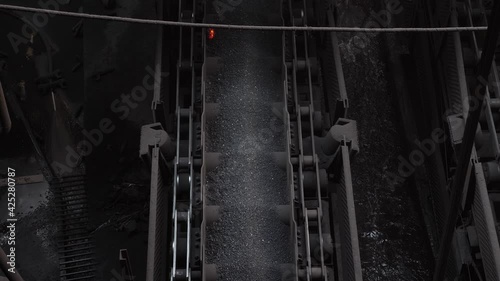 Sintering plant. Agglomerate moves along the conveyor belt.