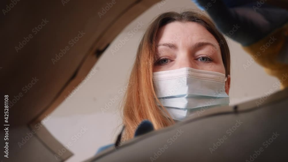 woman face in mask opens a packet bag of food meal. contactless ...