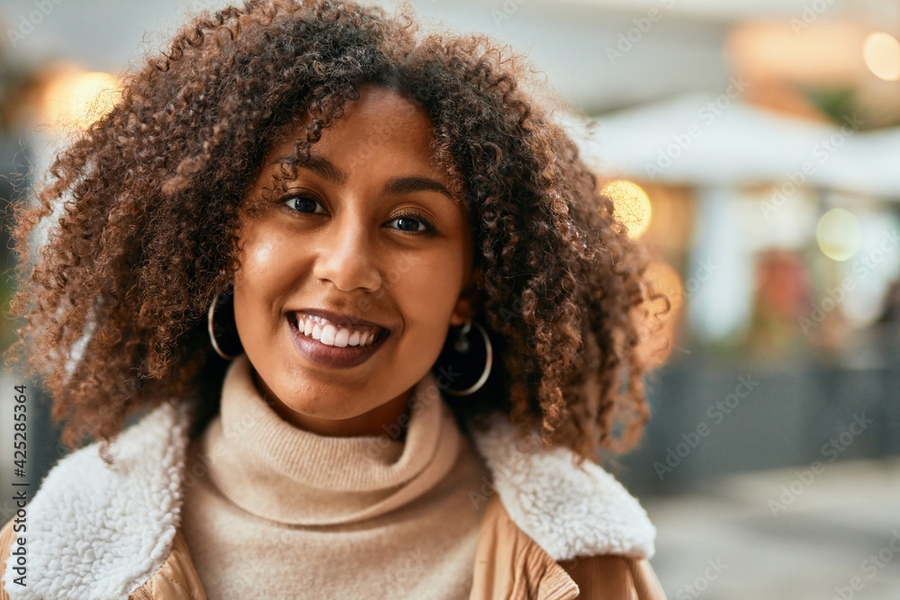 Young african american woman smiling happy standing at the city. Young african american woman smiling happy standing at the city.