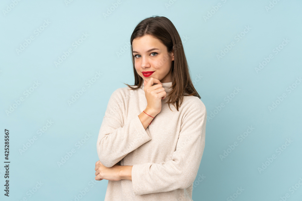 Teenager girl isolated on blue background laughing Teenager girl isolated on blue background laughing