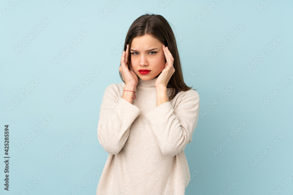 Teenager girl isolated on blue background unhappy and frustrated with something. Negative facial expression Teenager girl isolated on blue background unhappy and frustrated with something. Negative facial expression