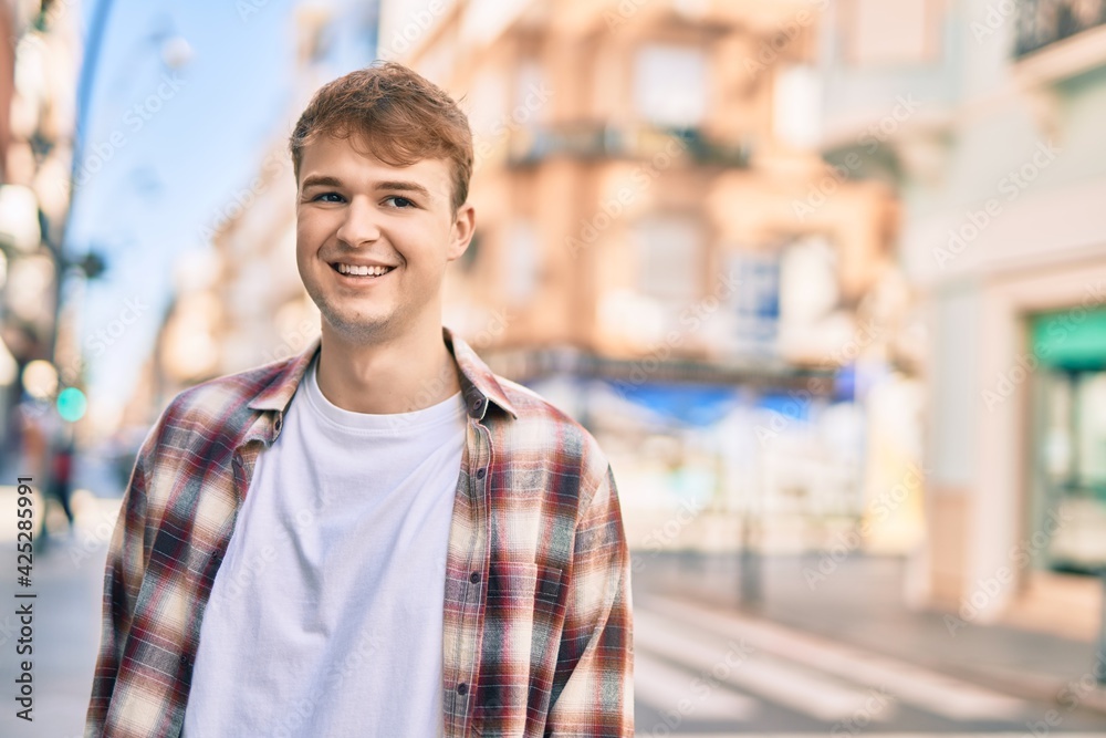Young caucasian man smiling happy standing at the city. Young caucasian man smiling happy standing at the city.