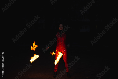 A girl shows a fire show
