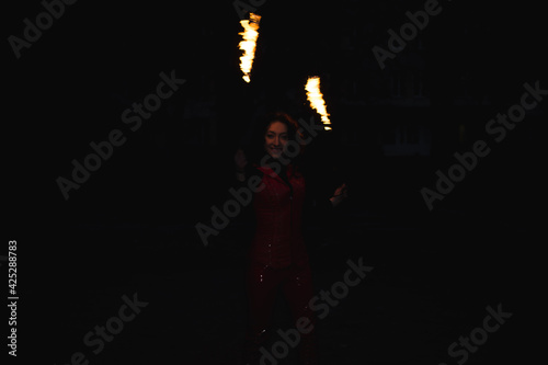 A girl shows a fire show
