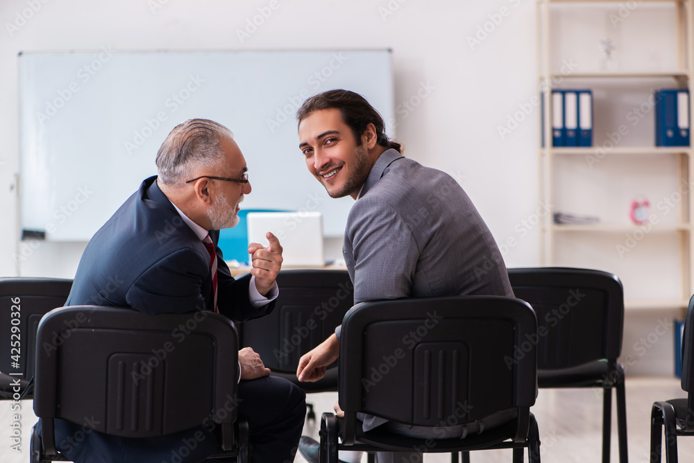 Two businessmen in the classroom in pandemic concept Two businessmen in the classroom in pandemic concept
