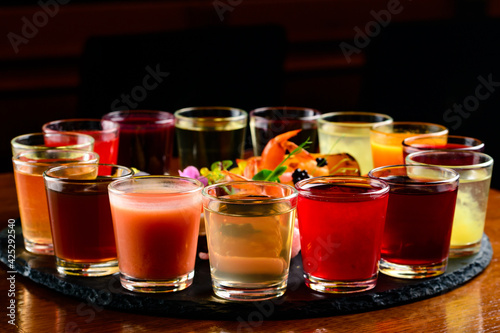 Colourful set of alcoholic cocktails in shot glasses shooters