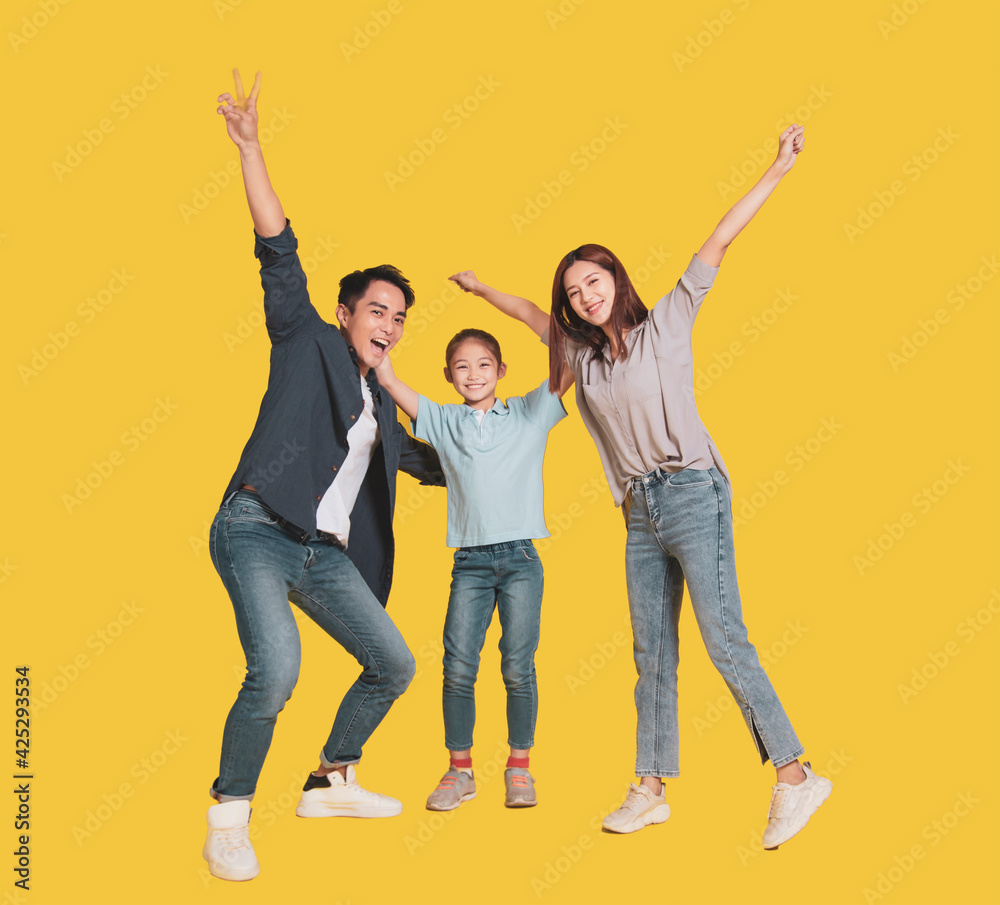 Happy Asian young family with one child standing embracing and smiling Happy Asian young family with one child standing embracing and smiling