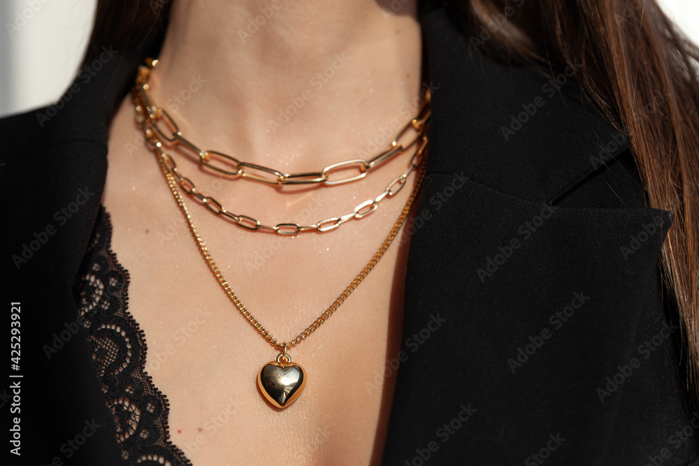 Beautiful model brunette in modern gold metal necklace chain Beautiful model brunette in modern gold metal necklace chain
