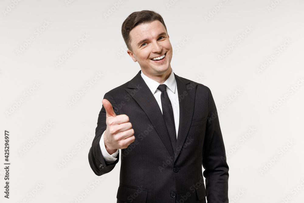 Young caucasian successful employee business corporate lawyer man in classic formal black grey suit shirt tie work in office show thumb up like gesture isolated on white background studio portrait Young caucasian successful employee business corporate lawyer man in classic formal black grey suit shirt tie work in office show thumb up like gesture isolated on white background studio portrait