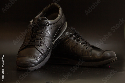 Black men's shoes on a black background
