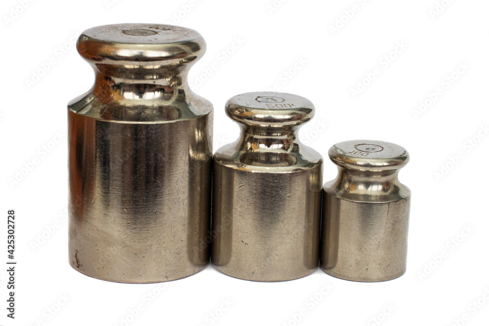 small weights from a chemical balance close-up on a white natural background small weights from a chemical balance close-up on a white natural background