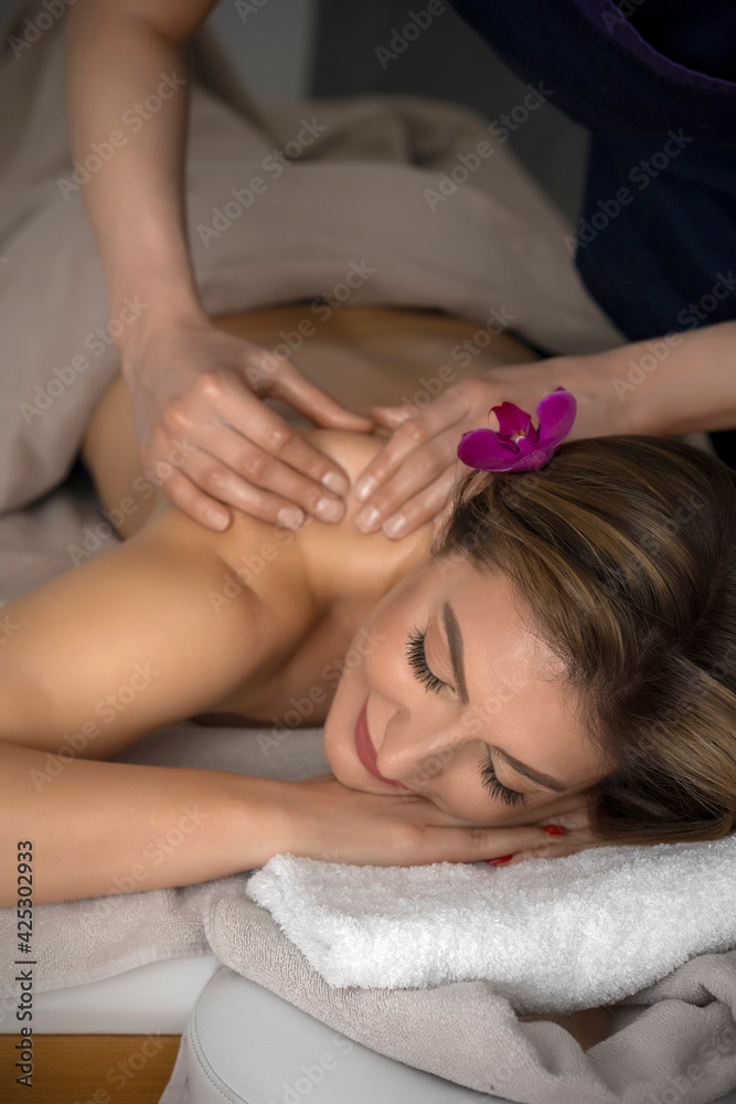 Woman doing relaxing back massage in spa center Woman doing relaxing back massage in spa center