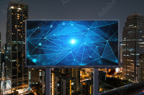 Information flow hologram on road billboard, night panorama city view of Bangkok. The largest technological center in Southeast Asia. The concept of programming science.