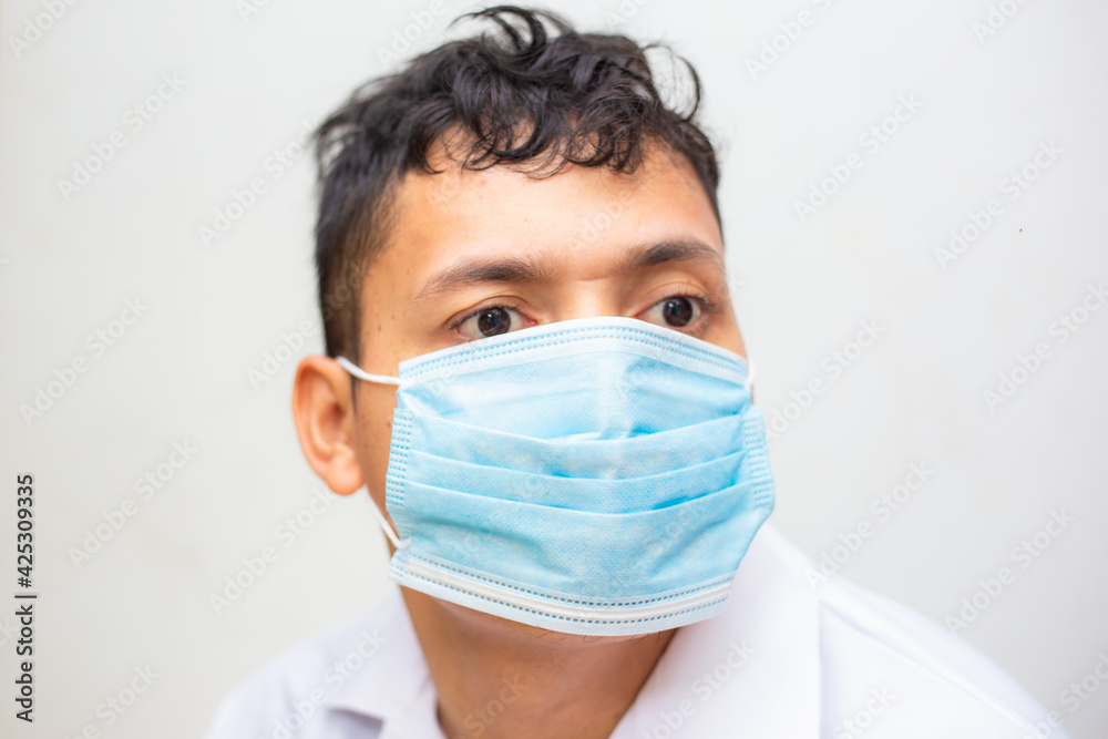 Young asian men wear surgical mask on white background