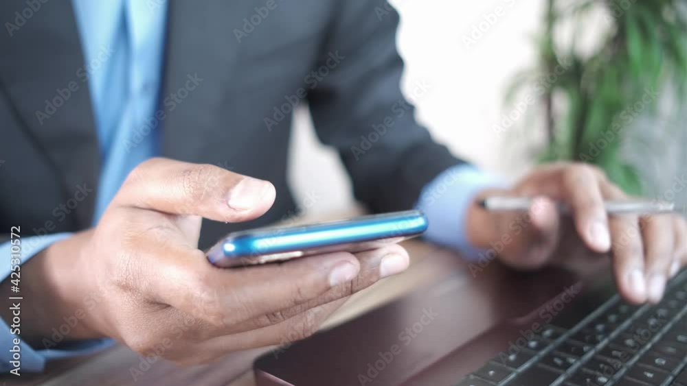businessmen using smart phone and typing on laptop 