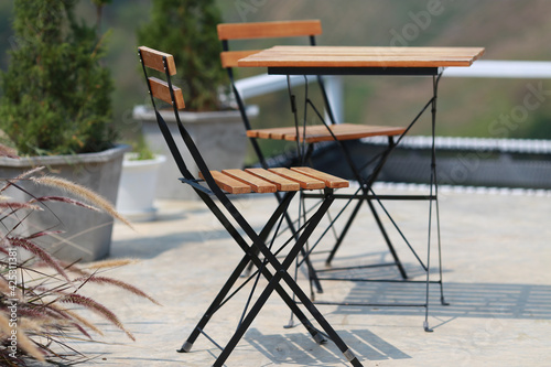 Orange wooden chairs and  wooden table for dining in cefe watch the nature view