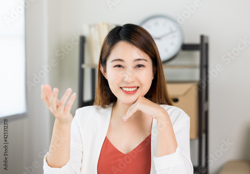 Young asian beautiful business woman meeting conference with team at home. Smiling charming happy young female talking discussion with camera.