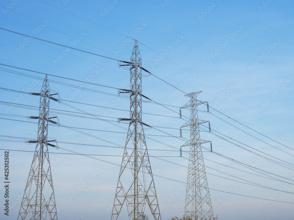 electricity power line on high voltage transmission towers over blue sky and white cloud background the energy infrastructure from power plant to industrial and household