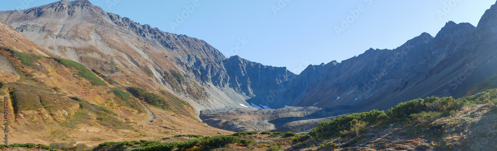 Panorama view of the volcano crater Vachkazhets mountain range. The remains of a large volcano crater attracts tourists with its unusual beauty. Kamchatka Peninsula, Russia.