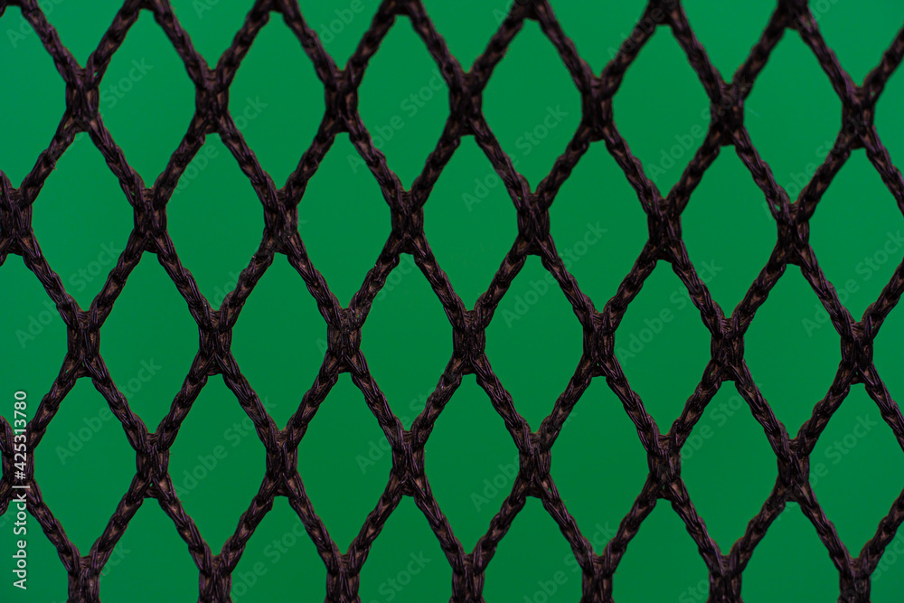 Fototapeta premium Silhouette of ropes that are bound together in a grid. on abstract green color.