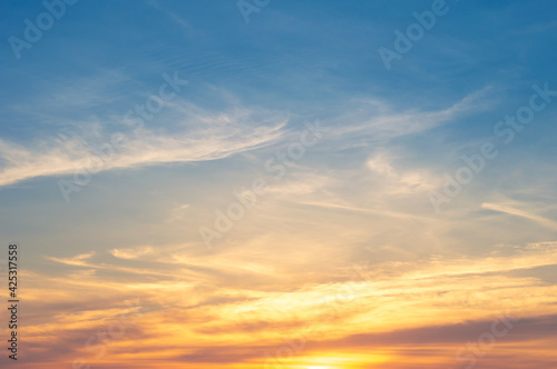 Fototapeta Naklejka Na Ścianę i Meble -  Beautiful Vivid sky painted by the sun leaving bright golden shades.Dense clouds in twilight sky in winter evening.Image of cloud sky on evening time.Evening Vivid sky with clouds.