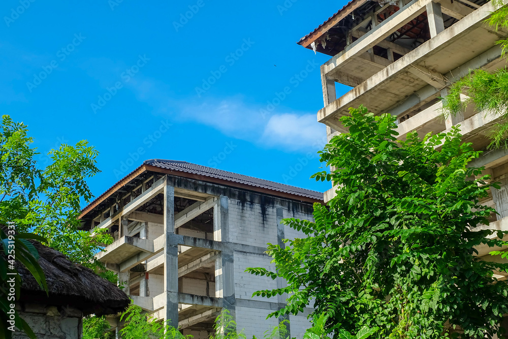 Abandoned buildings. Unfinished building. Wild gardens grow everywhere Abandoned buildings. Unfinished building. Wild gardens grow everywhere