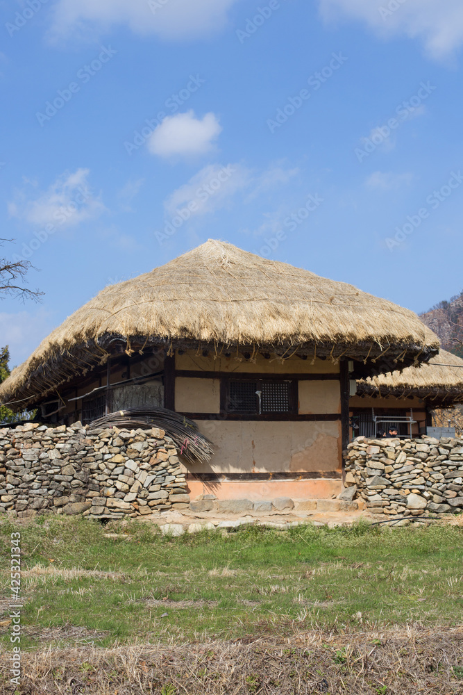 Traditional South Korean thatched roofed house. Roof made of straw.