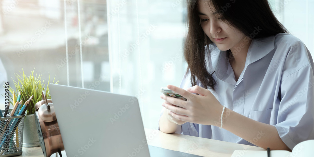 Portrait of woman using smartphone and smiling Portrait of woman using smartphone and smiling