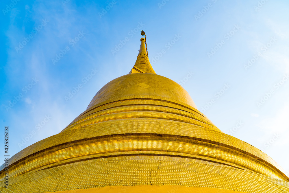 Stupa of Golden mountain or Wat sraket with blue sky and white cloud background. This is landmark in Bangkok, Thailand.