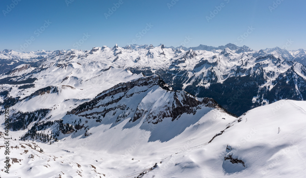 Swiss Alps. Peaks of mountains in snowdrifts. View from the top of Mount Stoss. Canton of Schwyz.