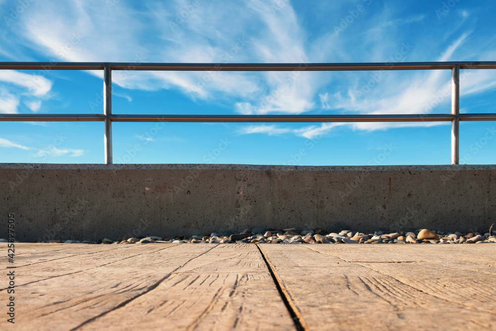 Metal barrier or railings between promenade and blue sky Metal barrier or railings between promenade and blue sky