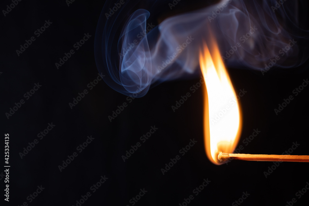 Macro shot of a burning match. Studio shot isolated on black background. Texture, Wallpaper Macro shot of a burning match. Studio shot isolated on black background. Texture, Wallpaper