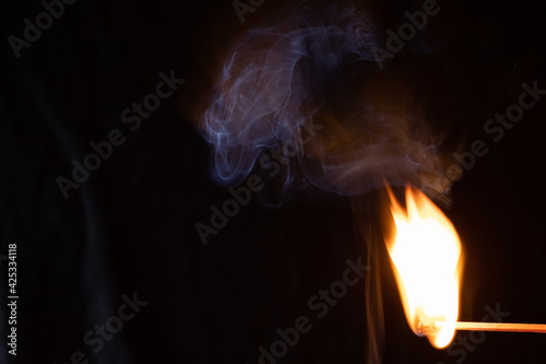 Macro shot of a burning match. Studio shot isolated on black background. Texture  Wallpaper