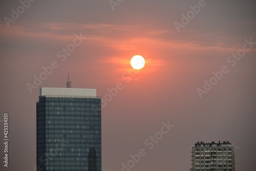 Sunset in the city over high office and residential buildings