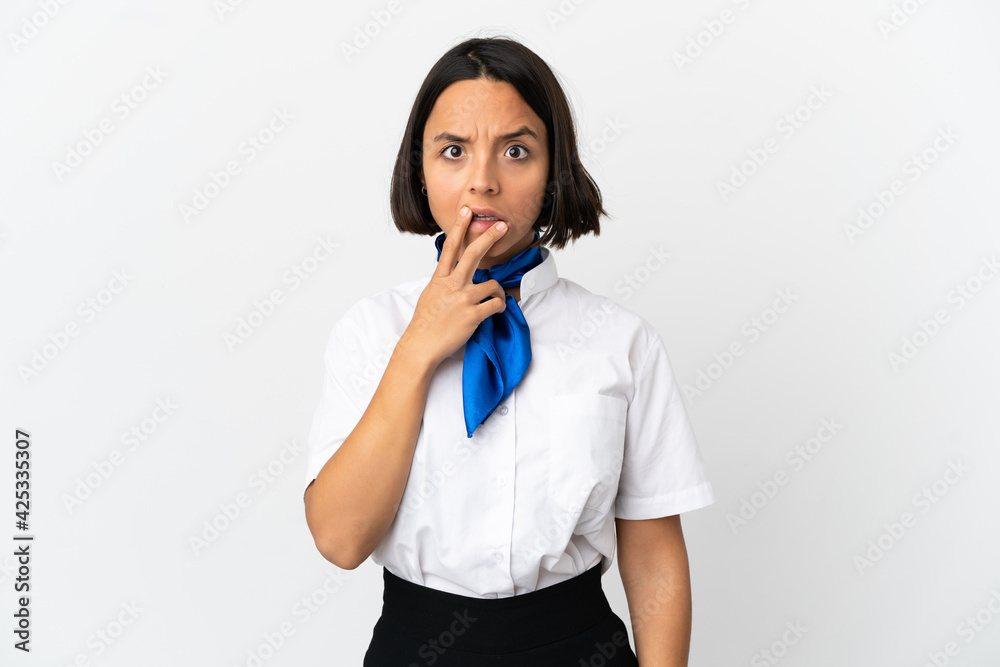 Airplane stewardess over isolated background surprised and shocked while looking right Airplane stewardess over isolated background surprised and shocked while looking right