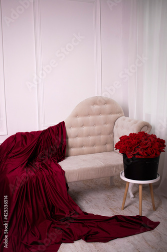 sofa and a large bouquet of roses in a bright room
