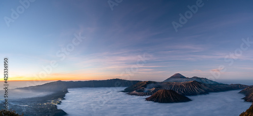 Panorama view of Mount Bromo volcano at sunrise in East Java, Indonesia surrounded by morning fog