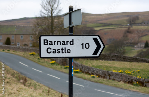 Barnard Castle signpost.  Black and white  10 miles sign, pointing right. Arkengarthdale, Yorkshire Dales. UK. Horizontal.  Space for copy. photo