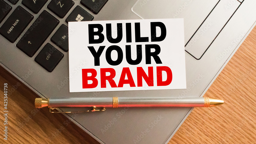 Notepad with inscriptions BUILD YOUR BRAND on a white background. business concept. Notepad with inscriptions BUILD YOUR BRAND on a white background. business concept.
