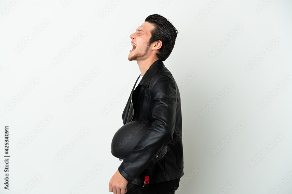 Russian man with a motorcycle helmet isolated on white background laughing in lateral position Russian man with a motorcycle helmet isolated on white background laughing in lateral position