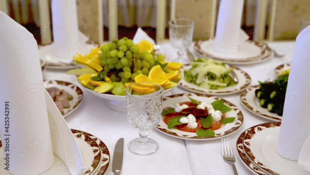 serving a large banquet table in a restaurant or at home for a holiday. serving a large banquet table in a restaurant or at home for a holiday.